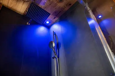 a bathroom with a shower with blue lights at Apartments Ciasa Costisela in San Vigilio Di Marebbe