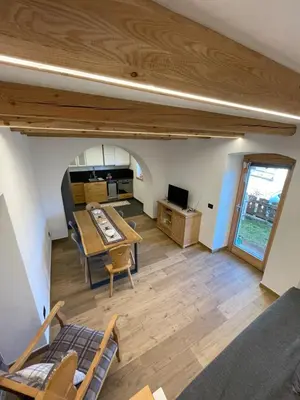 a living room with a table and a couch at Appartamento Gioia di Bosco in Carano