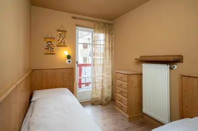 a bedroom with a bed and a window at Ciasa Buro - Zen in Moena