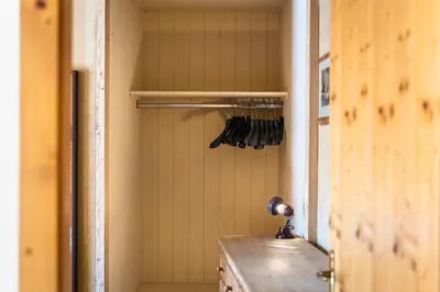 a closet with utensils hanging on a wall at Ciasa Buro - Zen in Moena