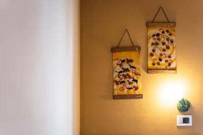 two paintings hanging on a wall next to a light at Ciasa Buro - Zen in Moena