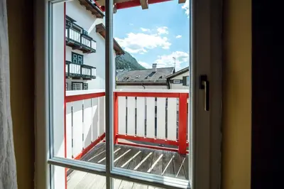 an open window with a view of a balcony at Ciasa Buro - Zen in Moena