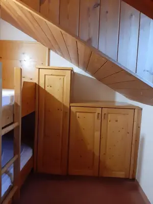 a room with two bunk beds and a staircase at loft panorama Tre cime Dobbiaco Cortina in Dobbiaco