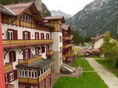 a view of a building with a mountain in the background at loft panorama Tre cime Dobbiaco Cortina in Dobbiaco