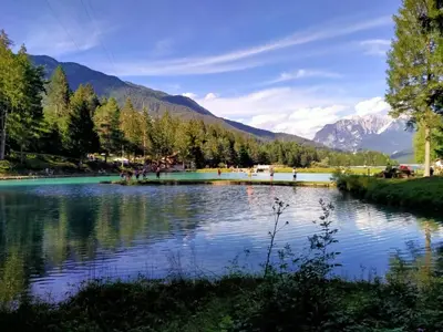 a view of a lake with mountains in the background at loft panorama Tre cime Dobbiaco Cortina in Dobbiaco