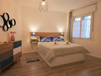 a bedroom with a large bed and a window at Tina's House - Alpine Stay Apartments in Cavalese