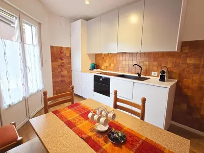 a kitchen with a table and a counter top at Tina's House - Alpine Stay Apartments in Cavalese