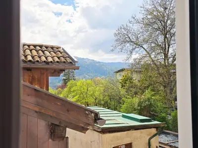 a view of a mountain from a window of a house at Tina's House - Alpine Stay Apartments in Cavalese