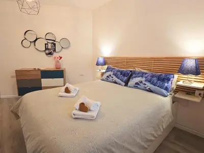 a bedroom with a bed with towels on it at Tina's House - Alpine Stay Apartments in Cavalese