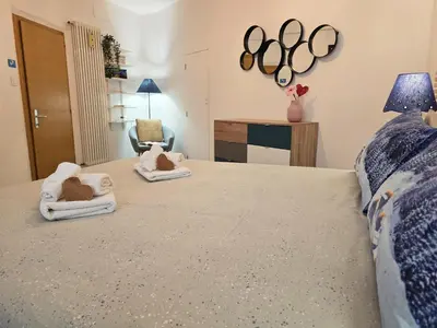 a bedroom with a bed with two towels on it at Tina's House - Alpine Stay Apartments in Cavalese