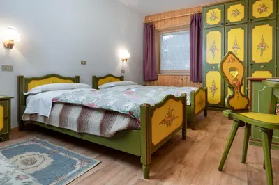 a bedroom with two beds and a table and a couch at Appartamento Brunel in Pera