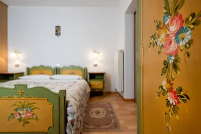 a bedroom with two beds and a table at Appartamento Brunel in Pera