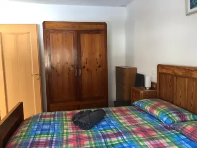 a bedroom with a bed with a hat on it at Appartamento Elisa in Taibon