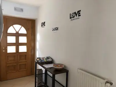 a room with a door and signs on the wall at Appartamento Elisa in Taibon