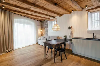 a kitchen and living room with a table in a room at Karcher-Hof Terlan in Terlano