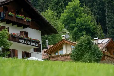 a bedroom with a bed with two towels on it at Cèsa Cherpei - Dog Friendly in Campitello di Fassa