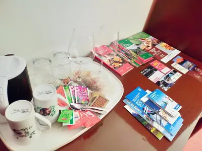 a table with a tray with wine glasses and towels at Cèsa Cherpei - Dog Friendly in Campitello di Fassa