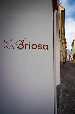 a sign for a buiscosa on the side of a building at Hotel La Briosa in Bolzano