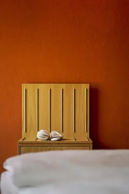 a bed with two shoes sitting on top of it at Hotel La Briosa in Bolzano