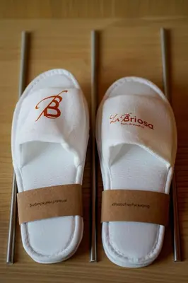 a pair of white shoes sitting on a table at Hotel La Briosa in Bolzano