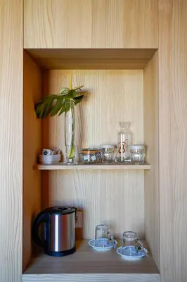 a wooden shelf with a pot and dishes on it at Hotel La Briosa in Bolzano