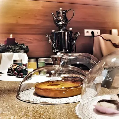 a glass plate with a donut under a glass dome on a counter at Hotel La Briosa in Bolzano