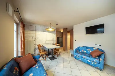 a living room with a couch and a table at Ciasa Buro - Coba in Moena