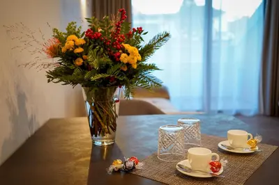 a vase of flowers sitting on top of a table at Your Stay in Bolzano in Bolzano