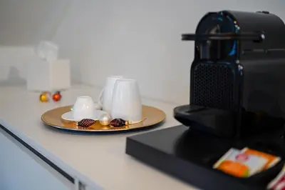 a plate of coffee cups on a counter with a camera at Your Stay in Bolzano in Bolzano