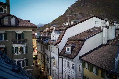 a group of buildings with a mountain in the background at Your Stay in Bolzano in Bolzano