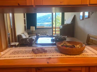 a kitchen with a table with a bowl on top of it at Encia's Home Dolomiti in Castello di Fiemme