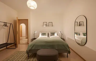 a bedroom with a large bed and a mirror at Argentieri City Loft in Bolzano