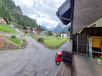 a small red car parked outside of a building at Contrin in Canazei