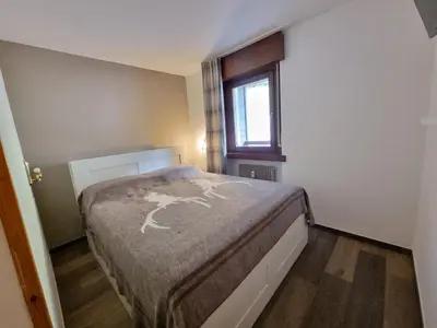 a bedroom with a bed in a room with a window at Contrin in Canazei