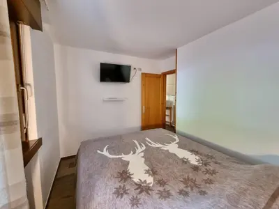 a bedroom with a bed with a deer stencil on it at Contrin in Canazei