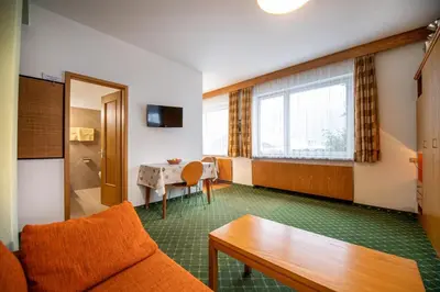 a living room with a couch and a table at Apartments Karl in Ortisei