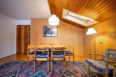 a dining room with a table and chairs and a couch at Apartments Karl in Ortisei