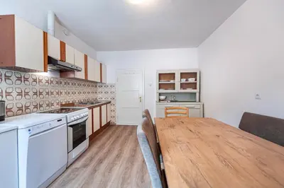 a kitchen with a wooden table in a room at Central Apartments Cristlpek in Ortisei