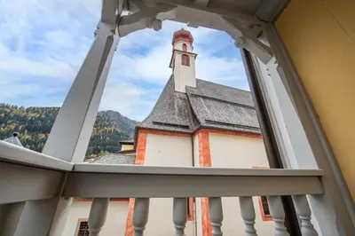 a view of a church from a window at Central Apartments Cristlpek in Ortisei