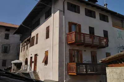a building with wooden balconies on the side of it at da Stoimenov in Fondo