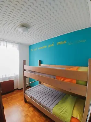 a bunk bed in a room with a blue wall at da Stoimenov in Fondo