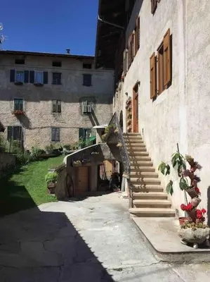 a building with stairs leading to a building with flowers at da Stoimenov in Fondo
