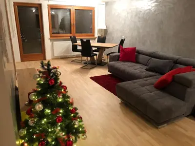 a living room with a christmas tree and a couch at Appartamento nuovo e comfort a Brunico Kronplatz in Brunico