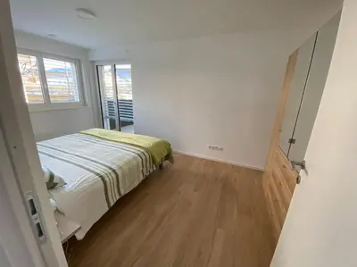 a small bedroom with a bed and a window at Via hofer in Brunico