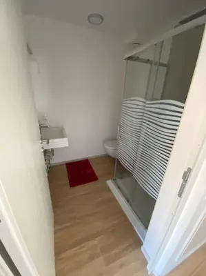 a bathroom with a sink and a toilet and a mirror at Via hofer in Brunico