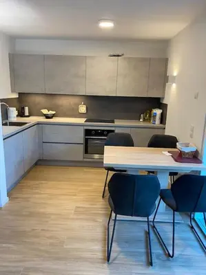 a kitchen with a table and chairs in it at Via hofer in Brunico