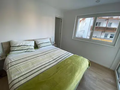 a bed in a room with a window at Via hofer in Brunico