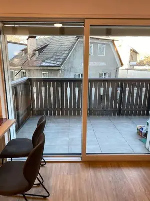 a room with a view of a balcony with a chair at Via hofer in Brunico