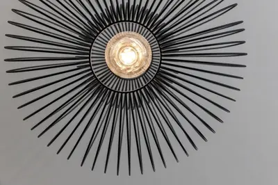a black metal fan with a light in the center at Villa Stubai Garden Suite in Merano