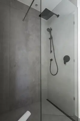a shower with a glass door in a bathroom at Villa Stubai Garden Suite in Merano